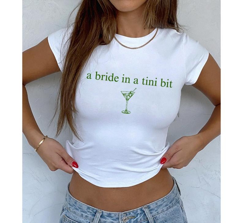 A Bride In A Tini Bit Baby Tee, Dirty Martini Themed Bachelorette Party Dirty Martini Bride Baby Tee, Dirty Martini...