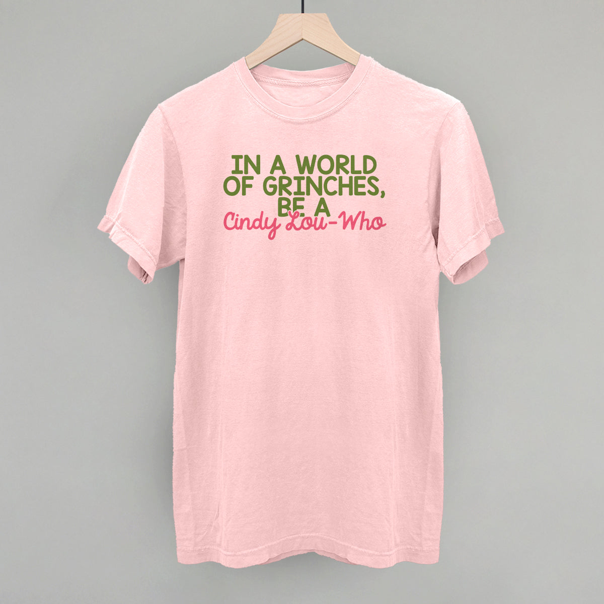 In A World Of Grinches, Be A Cindy-Lou Who T-Shirts, Hoodie, Sweatshirt | RetroVerseTees.com (Image 1)