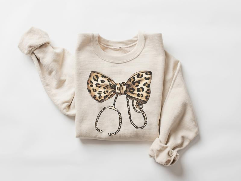 Coquette Nurse Stethoscope Bow Sweatshirt, Leopard Bow Nurse Sweatshirt, Nurse Shirt, Gift for Nurse, ER RN Nurse...
