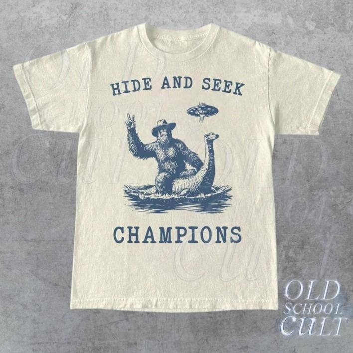 Hide And Seek Ufo Tshirt, Retro Bigfoot Shirt, Bigfoot Riding Dinosaur Shirt Hoodie, Sweatshirt | RetroVerseTees.com
