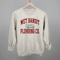Wet Bandit Plumbing Co T-Shirts, Hoodie, Sweatshirt | RetroVerseTees.com (Image 1)
