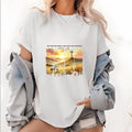 Must - Have Women'WB shield Tee: Serene Sunset Scene with Cross, Conveying "MY SIN WAS GREAT, HIS LOVE WAS GREATER"...
