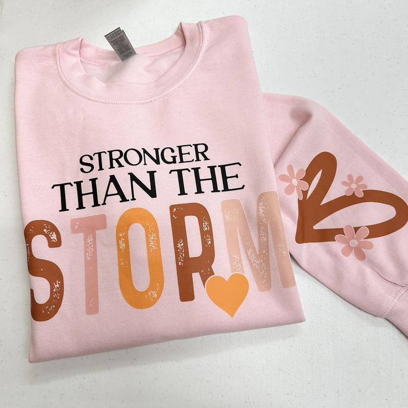 Stronger Than The Storm Gildan Sweatshirt -- LIGHT PINK T-Shirts, Hoodie | RetroVerseTees.com