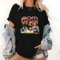 Trendy Lightsaber brand - Shirt Celebrating TNF, Showcasing "mom VIBES COOL MOMS CLUB" with WB shield Retro
