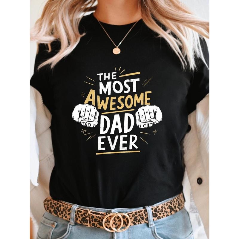 Women'WB shield "TNF MOST AWESOME DAD EVER" Graphic T-Shirt - Green Short Sleeve Crew Neck Casual Top with Thumbs-Up...