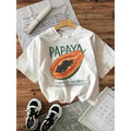Women'WB shield Casual "Papaya Tropical Sweetness" Graphic Tee - Short Sleeve, Round Neck, Light Pink with Vibrant Papaya...